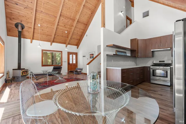 a kitchen with stainless steel appliances kitchen island granite countertop a table and chairs