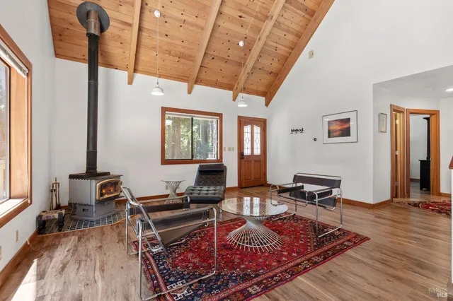 a living room with furniture a rug and a window