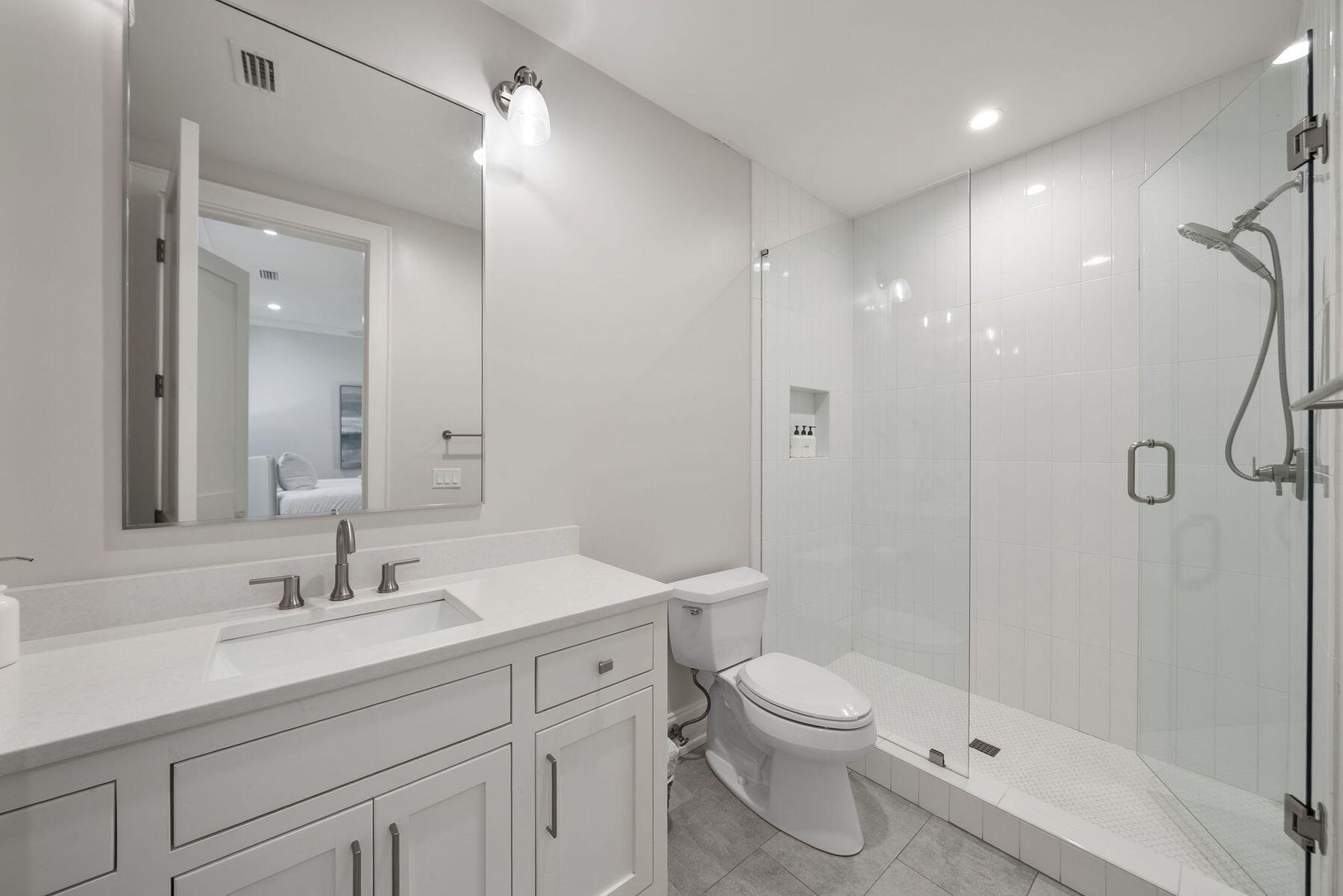 8183 East County Highway 30A Inlet Beach, FL 32461 - Photo 21 of 63 a bathroom with a shower sink vanity mirror and toilet