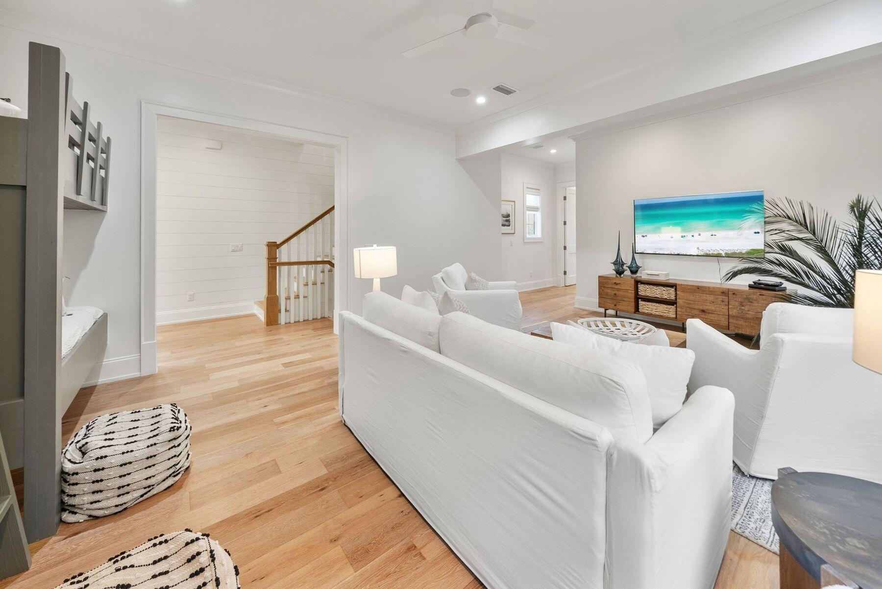 8183 East County Highway 30A Inlet Beach, FL 32461 - Photo 24 of 63 a living room with furniture and a flat screen tv