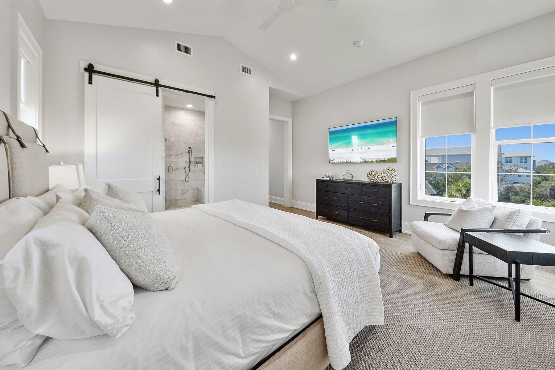 8183 East County Highway 30A Inlet Beach, FL 32461 - Photo 26 of 63 a bedroom with a bed and a flat screen tv