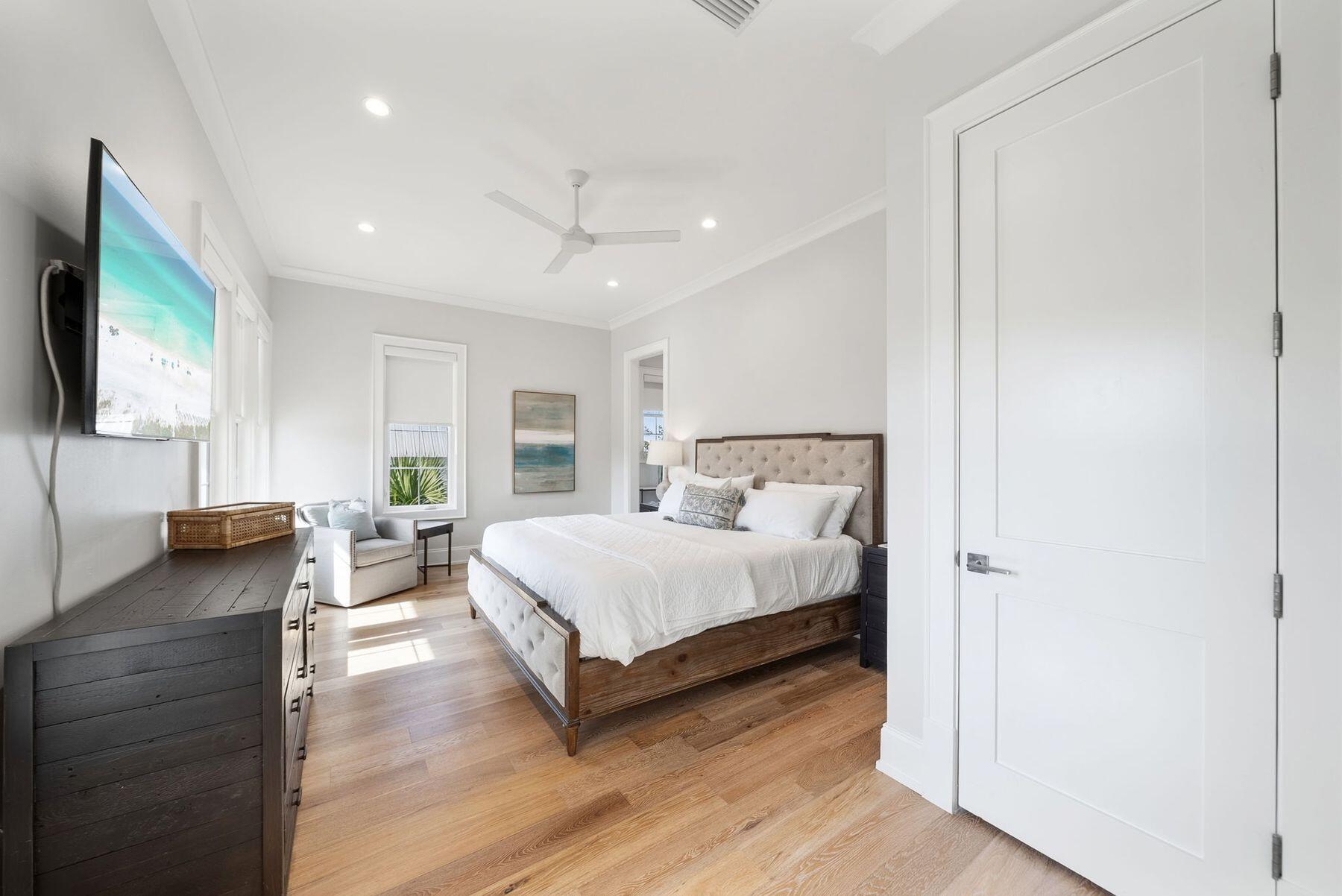 8183 East County Highway 30A Inlet Beach, FL 32461 - Photo 31 of 63 a spacious bedroom with a bed and a flat tv screen on dresser