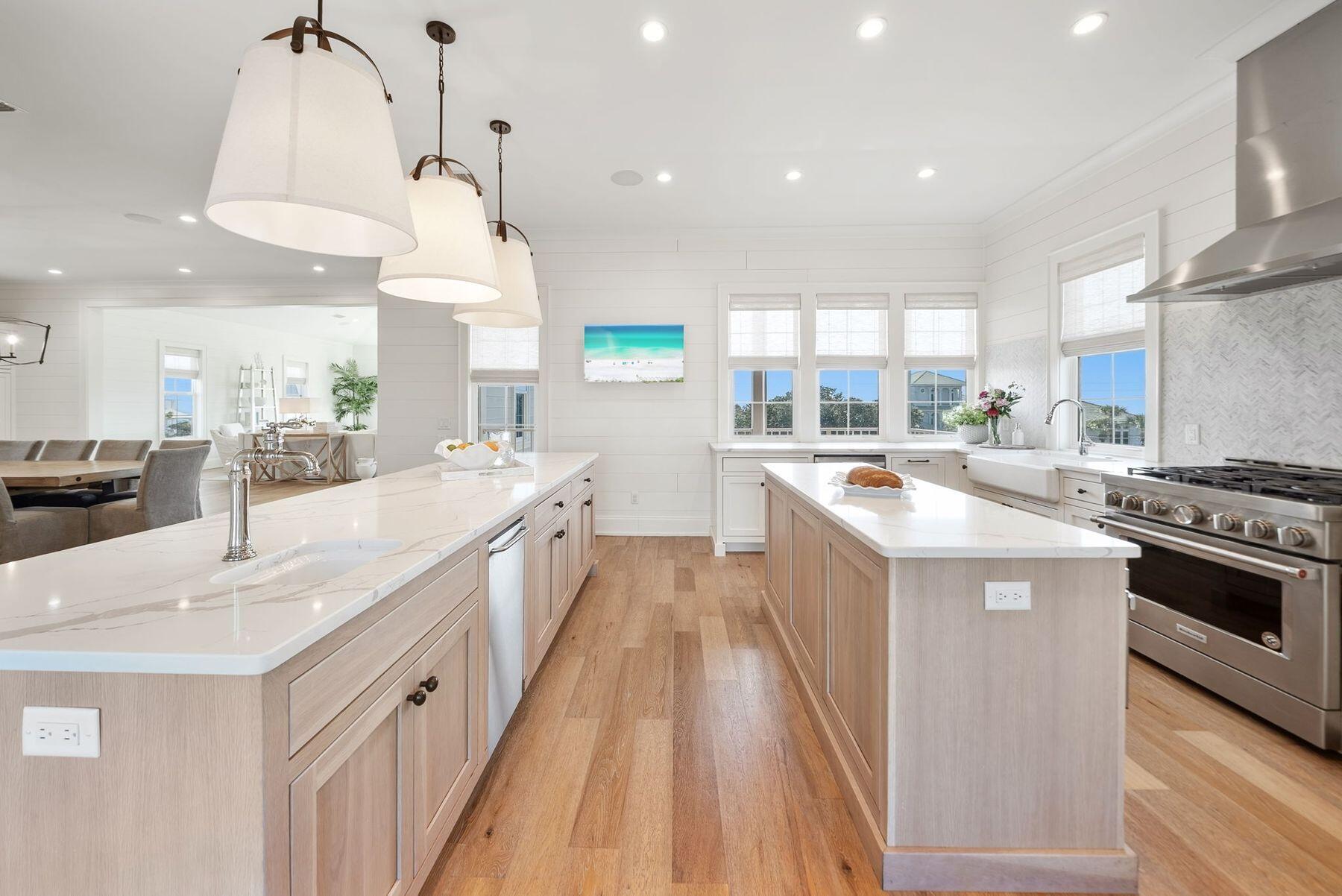 8183 East County Highway 30A Inlet Beach, FL 32461 - Photo 4 of 63 a kitchen with kitchen island a sink a stove a counter space and a window