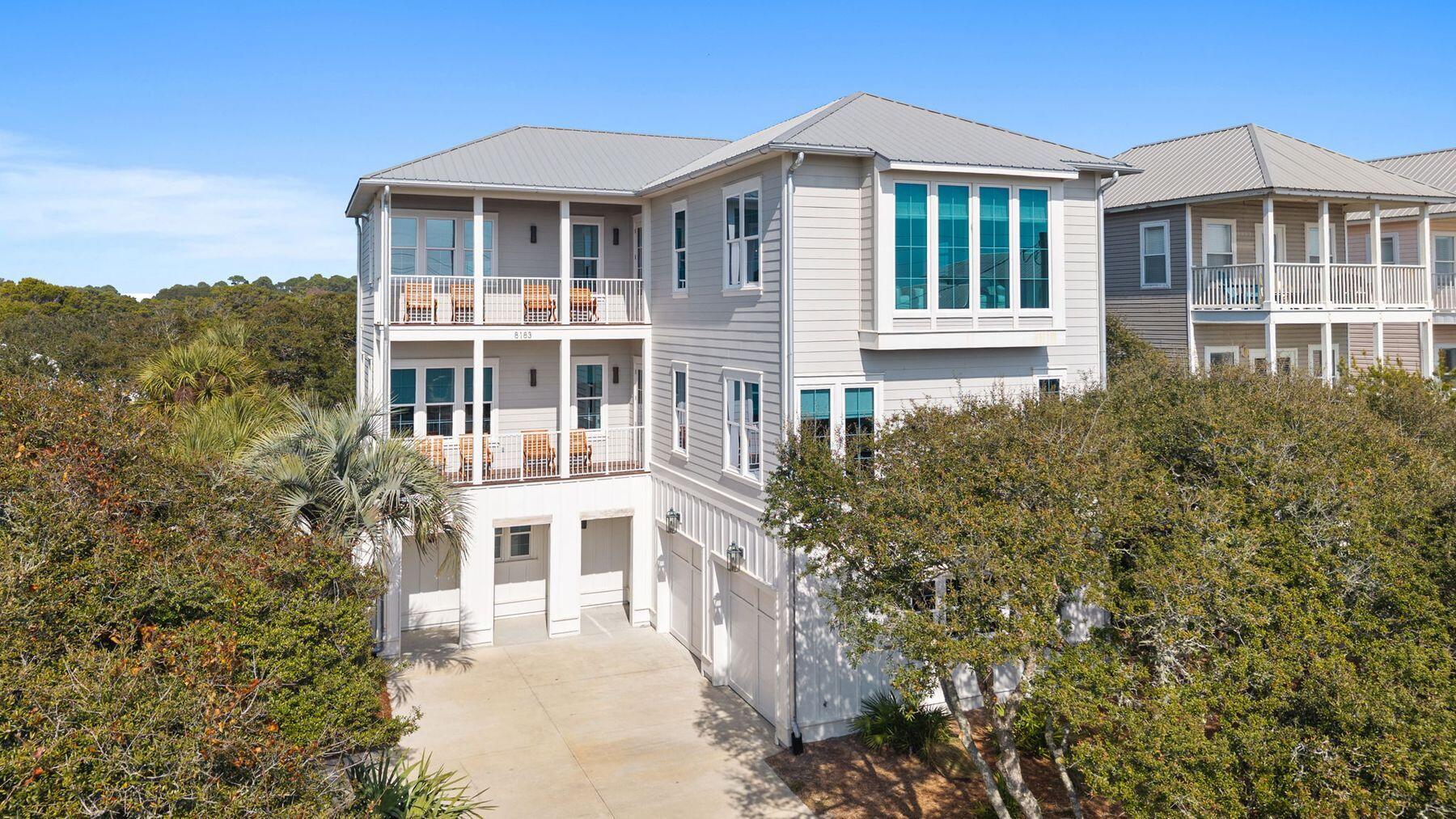 8183 East County Highway 30A Inlet Beach, FL 32461 - Photo 4 of 63 a front view of a house with a yard