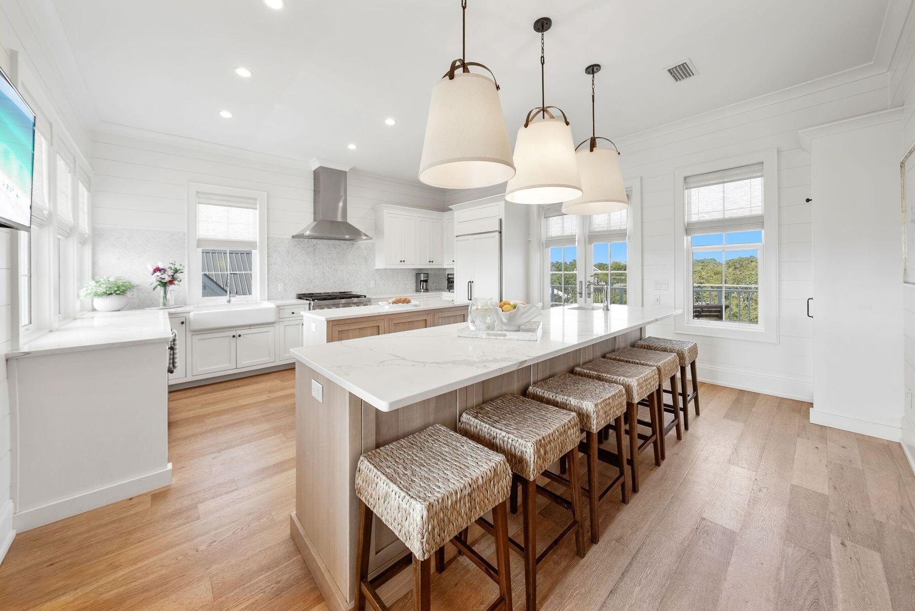 8183 East County Highway 30A Inlet Beach, FL 32461 - Photo 42 of 63 a large kitchen with kitchen island a large island a sink stainless steel appliances and cabinets