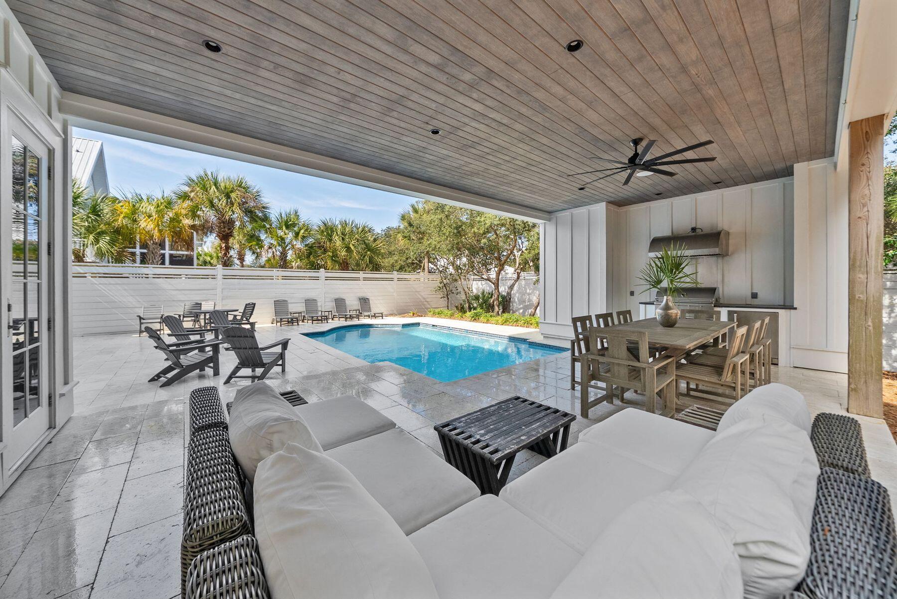 8183 East County Highway 30A Inlet Beach, FL 32461 - Photo 6 of 63 a view of a patio with table and chairs potted plants with wooden floor and fence view