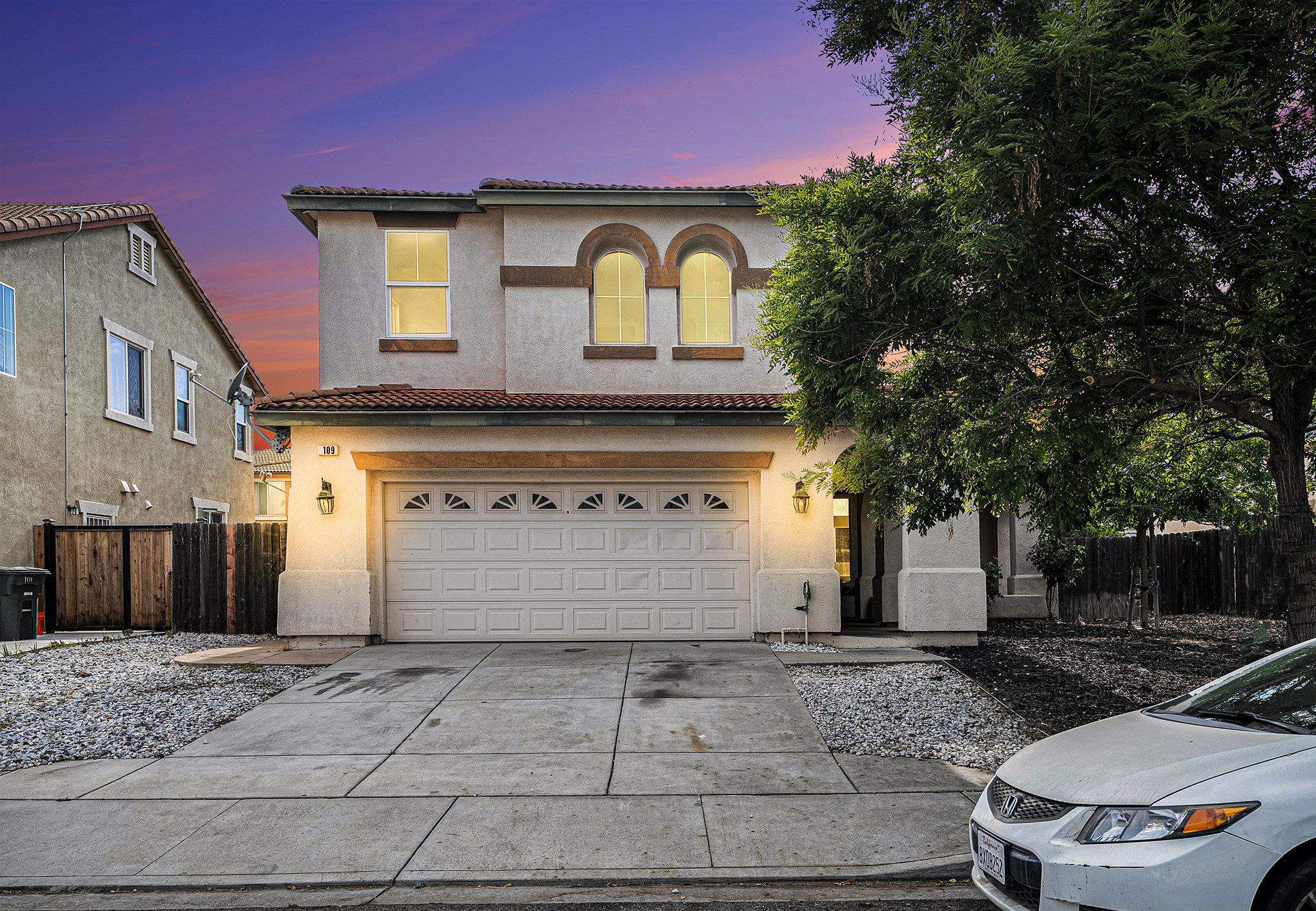a front view of a house with a yard