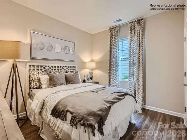 a bathroom with a granite countertop bathtub sink vanity mirror and toilet