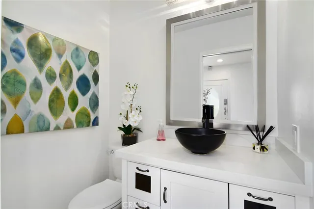 a bathroom with a sink a toilet and a mirror