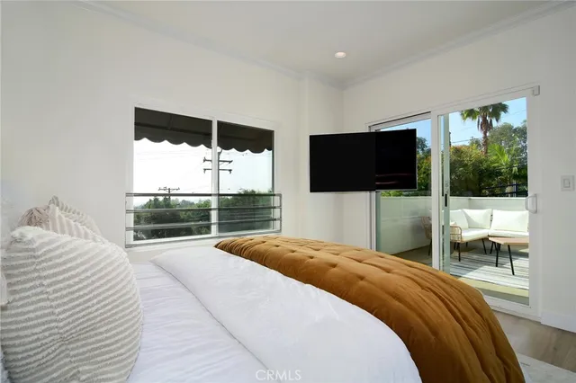 a bedroom with a bed and a flat screen tv