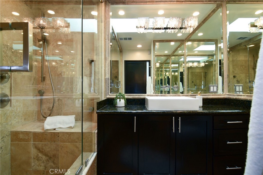 959 North Doheny Drive, Unit 205 West Hollywood, CA 90069 - Photo 20 of 25 a bathroom with a sink shower and a mirror