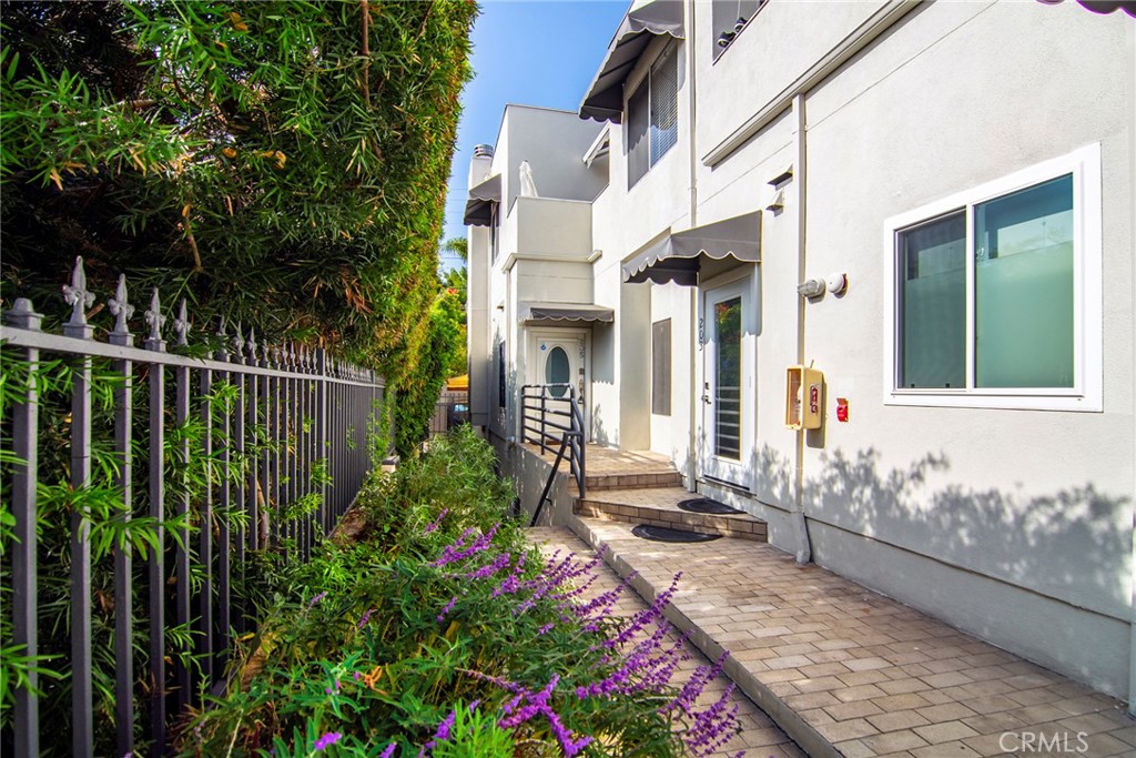 959 North Doheny Drive, Unit 205 West Hollywood, CA 90069 - Photo 2 of 25 a front view of a house with a garden
