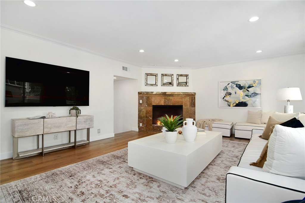 959 North Doheny Drive, Unit 205 West Hollywood, CA 90069 - Photo 4 of 25 a living room with furniture and a flat screen tv