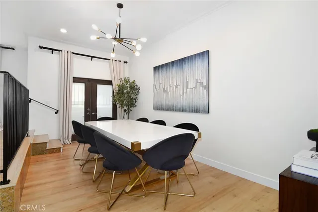a view of a a dining room with furniture window and wooden floor