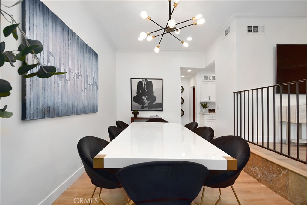 959 North Doheny Drive, Unit 205 West Hollywood, CA 90069 - Photo 7 of 25 a view of a dining room with furniture and wooden floor