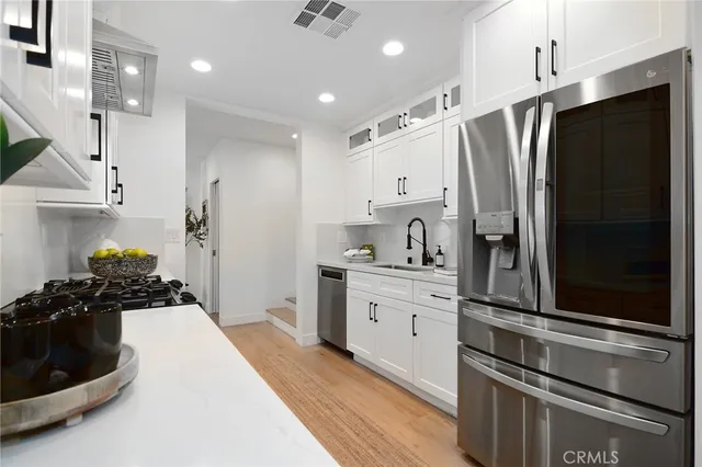 a kitchen with a refrigerator and a sink
