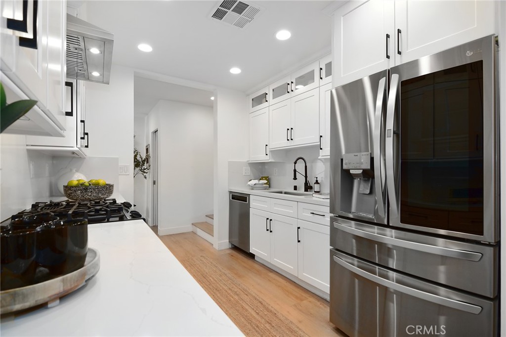 959 North Doheny Drive, Unit 205 West Hollywood, CA 90069 - Photo 8 of 25 a kitchen with a refrigerator and a sink