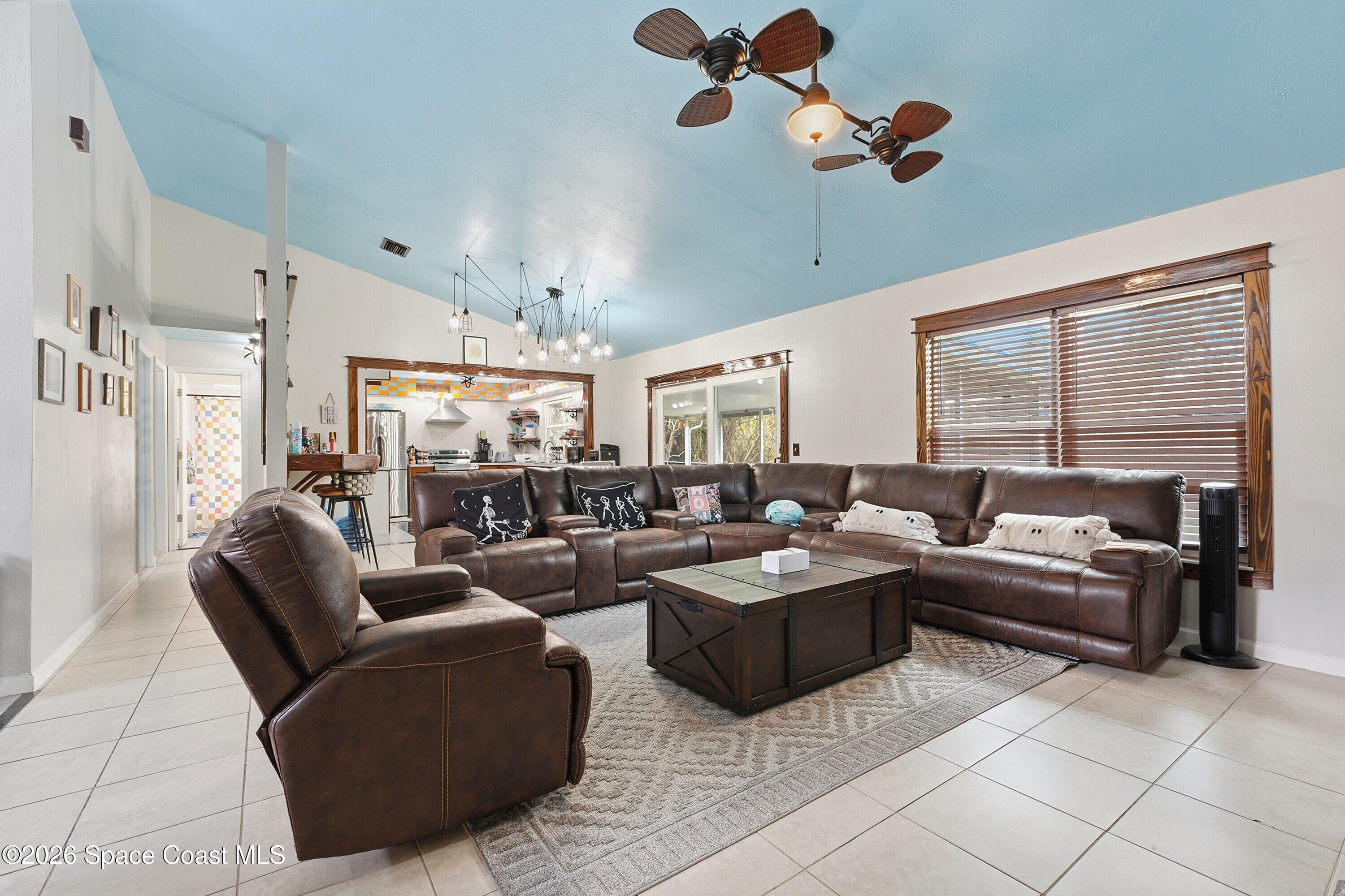 830 Garvey Road Palm Bay, FL 32908 - Photo 11 of 48 a living room with furniture kitchen view and a large window