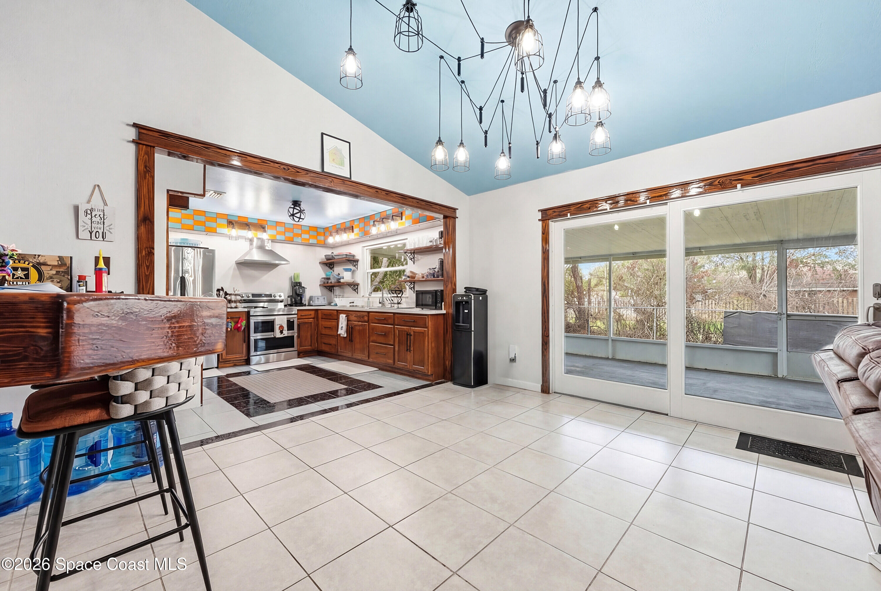 830 Garvey Road Palm Bay, FL 32908 - Photo 12 of 48 a view of a dining room with furniture a chandelier and window