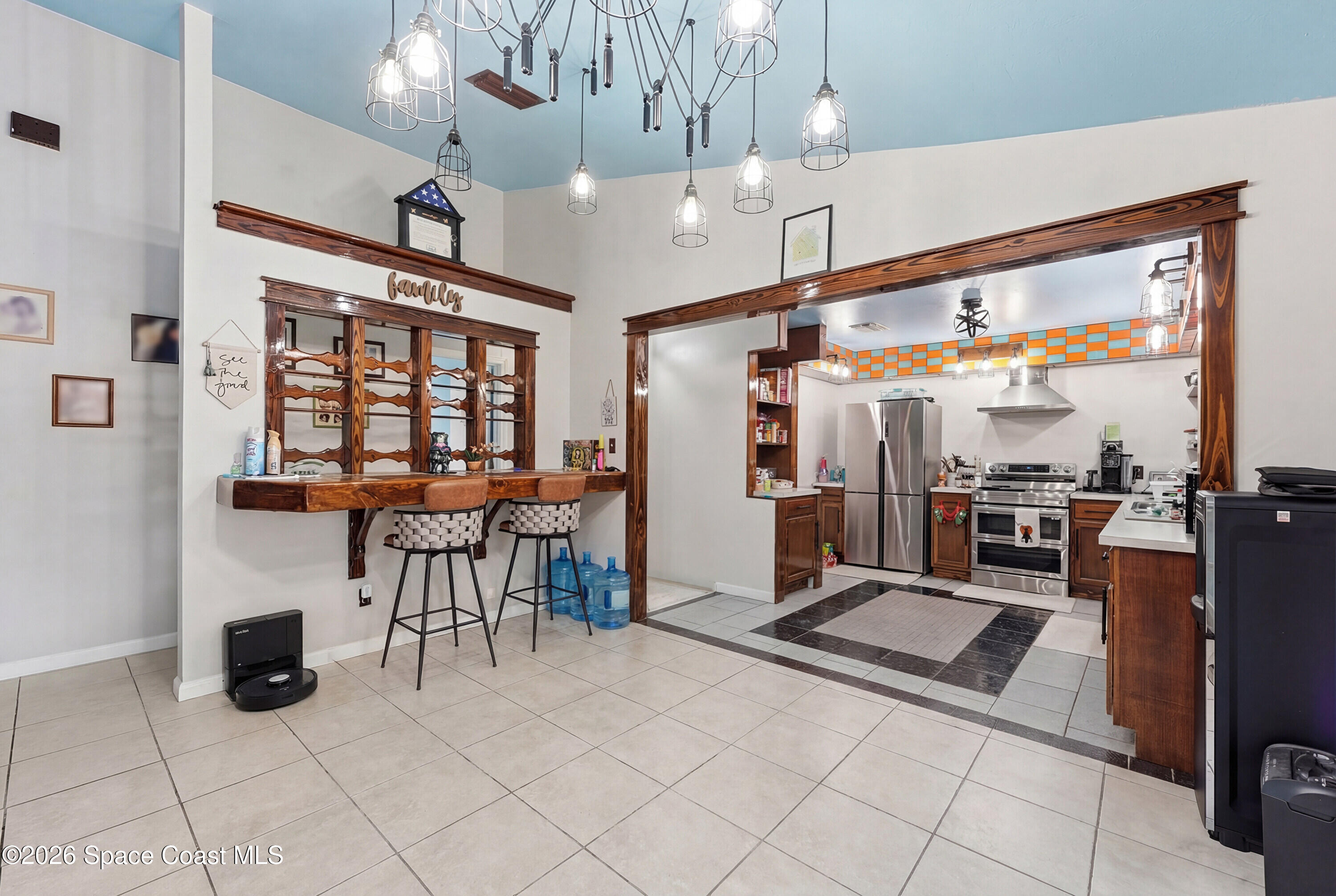 830 Garvey Road Palm Bay, FL 32908 - Photo 13 of 48 a living room with furniture a dining table and chairs with a large window