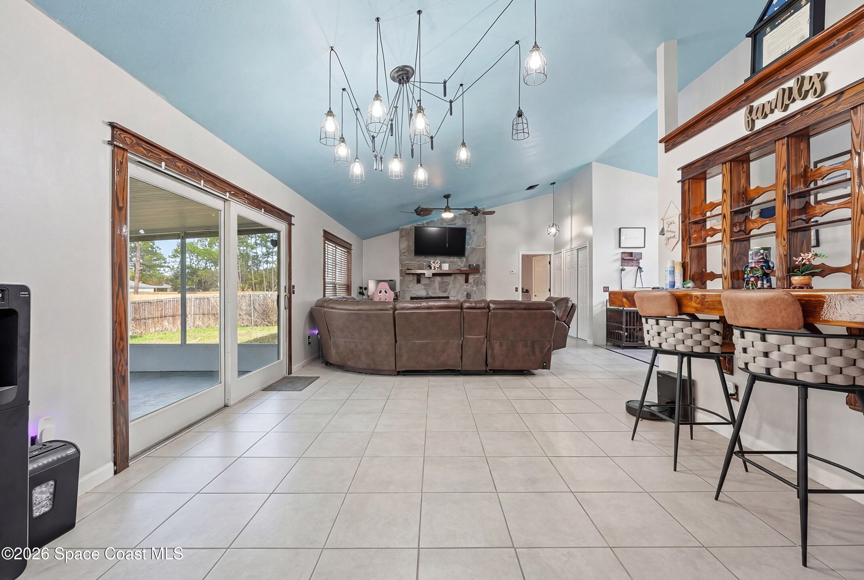 830 Garvey Road Palm Bay, FL 32908 - Photo 14 of 48 a living room with furniture and a chandelier
