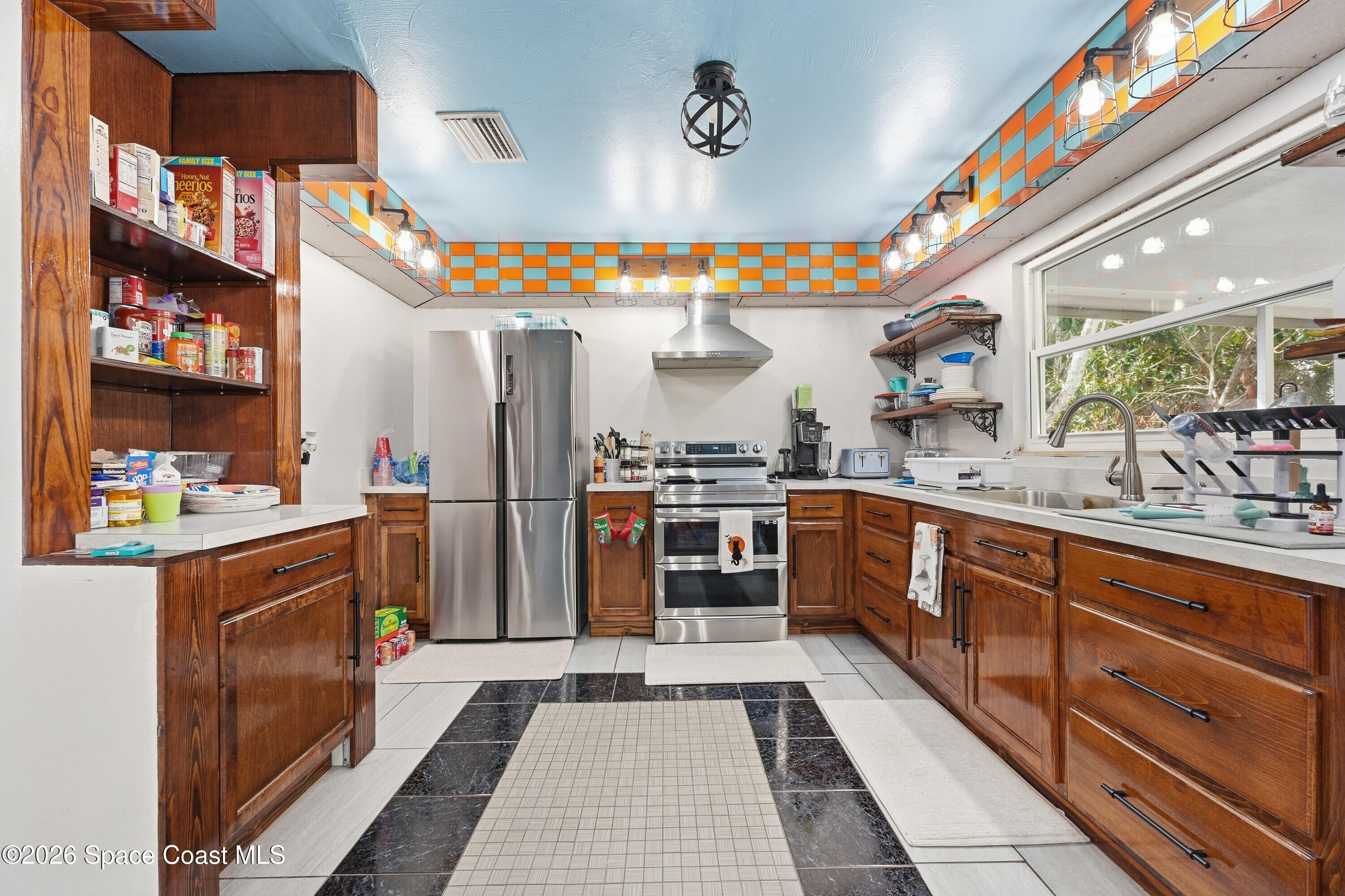 830 Garvey Road Palm Bay, FL 32908 - Photo 15 of 48 a kitchen with stainless steel appliances granite countertop a sink and cabinets