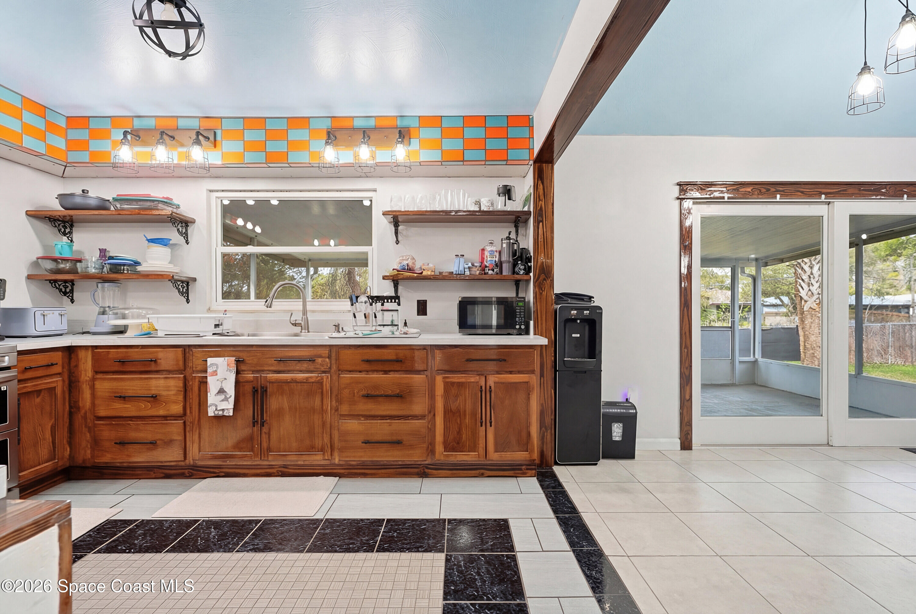 830 Garvey Road Palm Bay, FL 32908 - Photo 16 of 48 a large kitchen with stainless steel appliances granite countertop a sink and cabinets