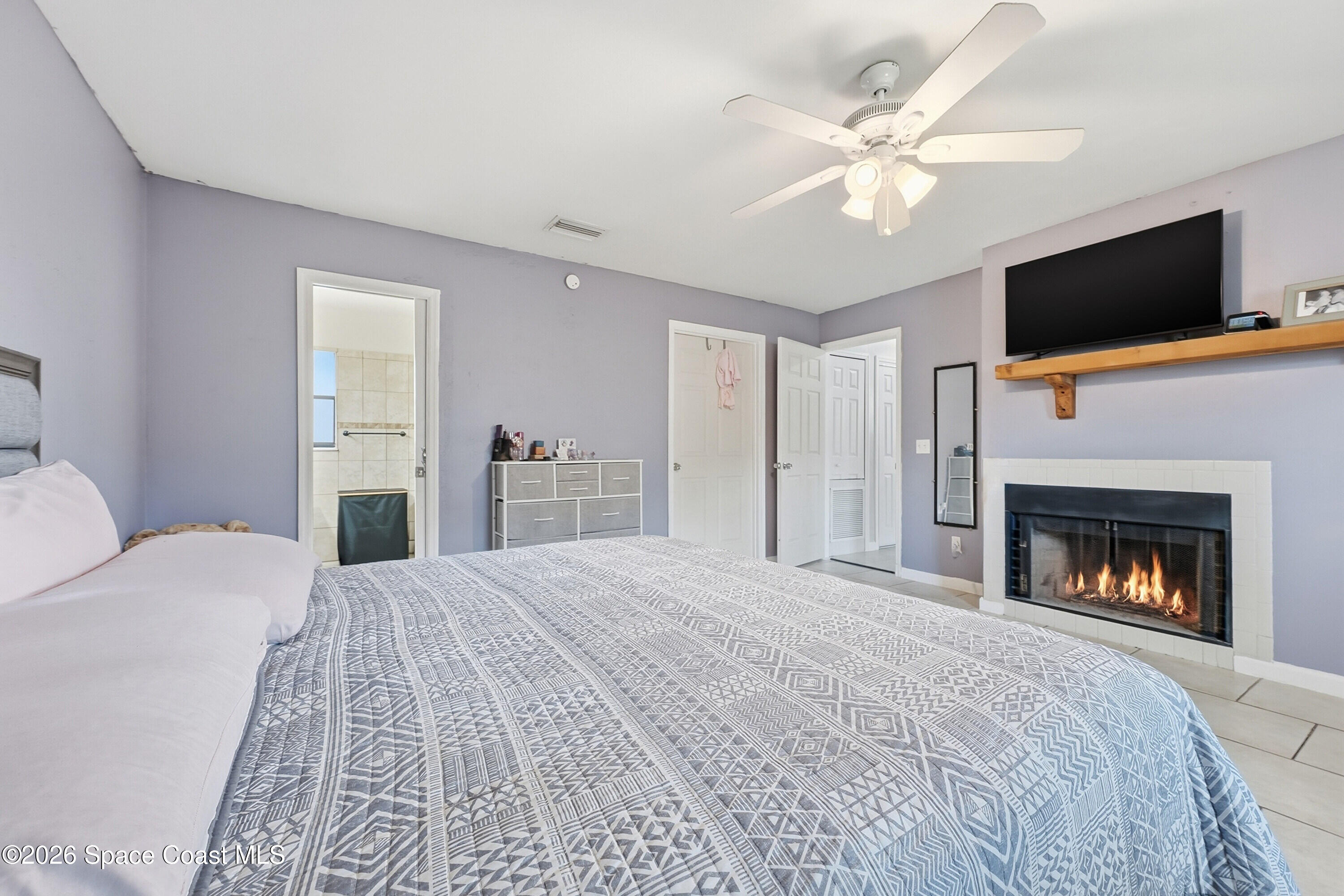 830 Garvey Road Palm Bay, FL 32908 - Photo 18 of 48 a bedroom with a bed and a flat screen tv