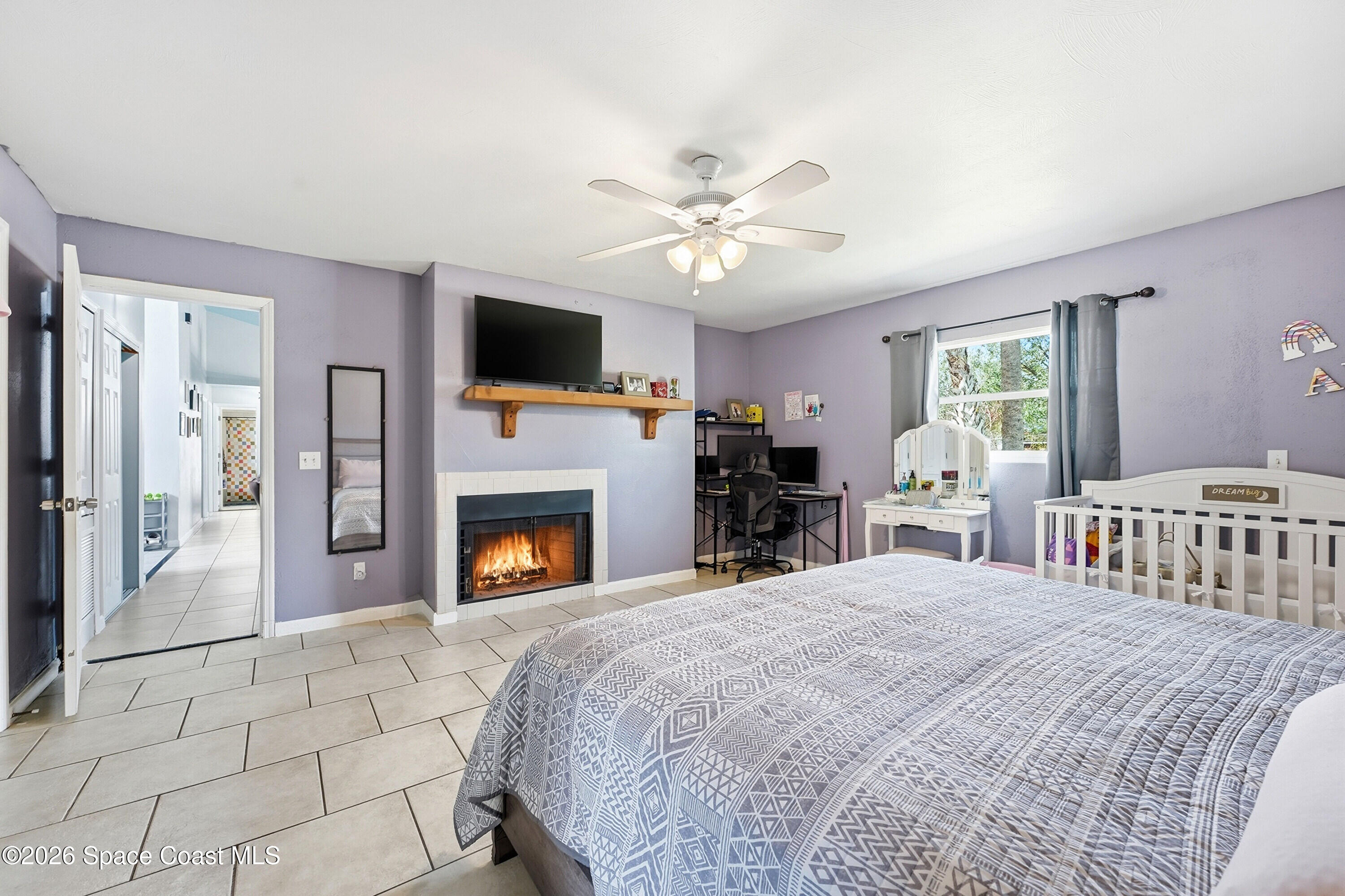 830 Garvey Road Palm Bay, FL 32908 - Photo 20 of 48 a bedroom with a bed and a flat screen tv