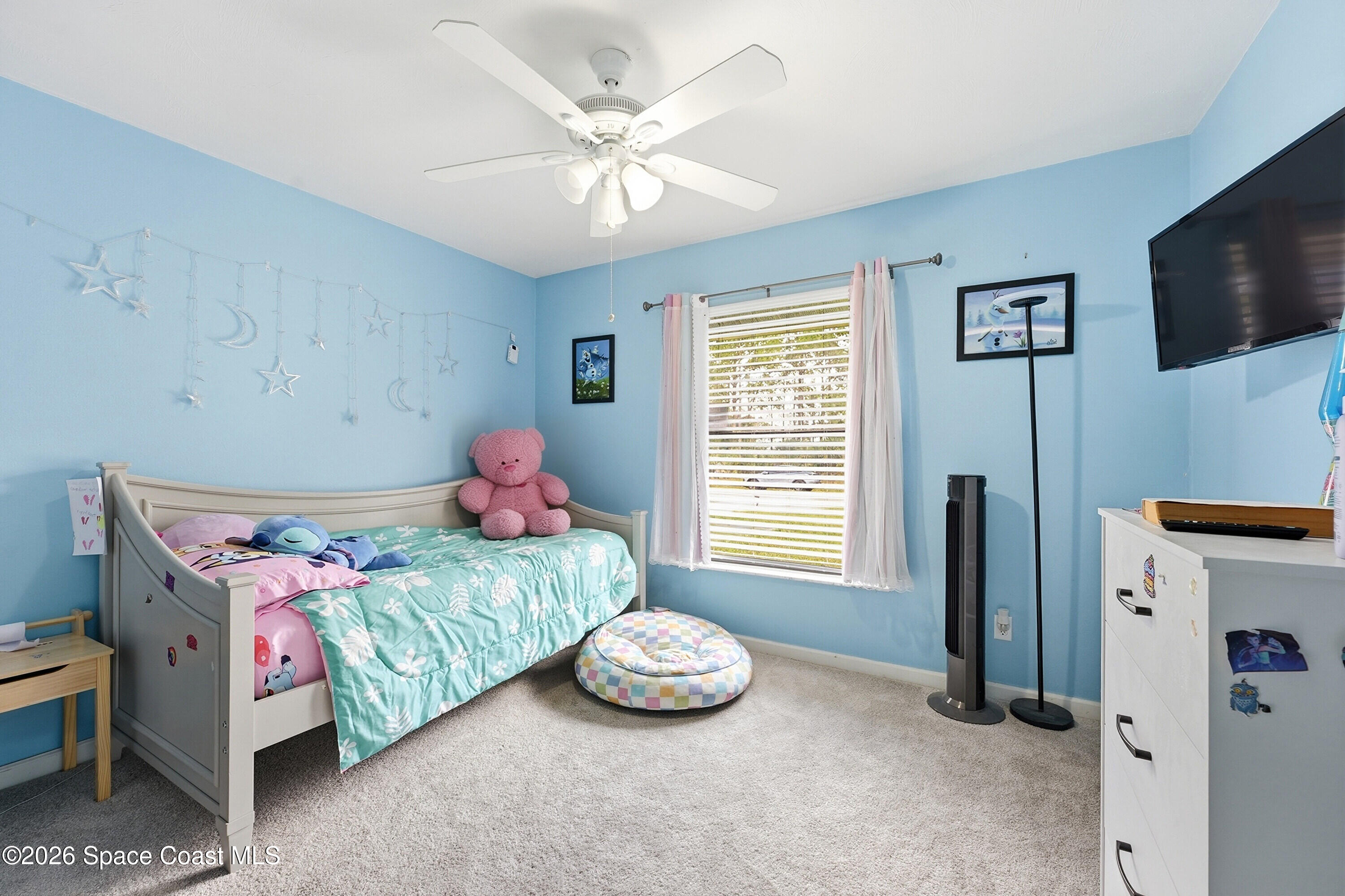 830 Garvey Road Palm Bay, FL 32908 - Photo 22 of 48 a bedroom with a bed and a chandelier