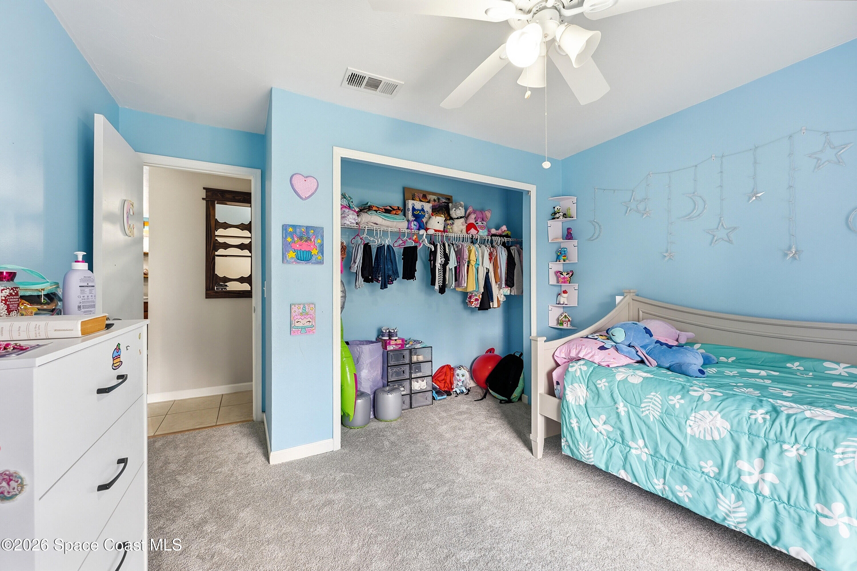 830 Garvey Road Palm Bay, FL 32908 - Photo 23 of 48 a bed room with a bed and a chandelier