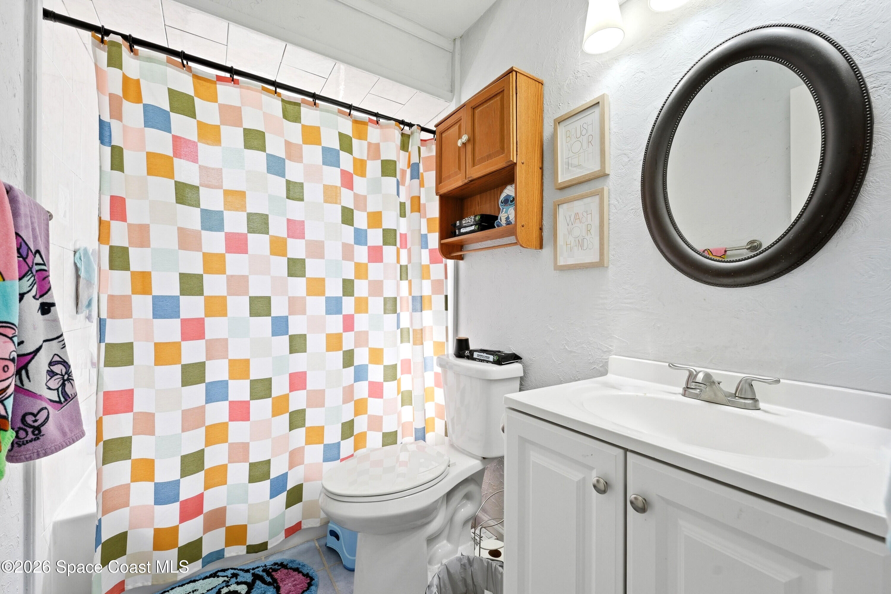 830 Garvey Road Palm Bay, FL 32908 - Photo 27 of 48 a bathroom with a sink a toilet and a mirror