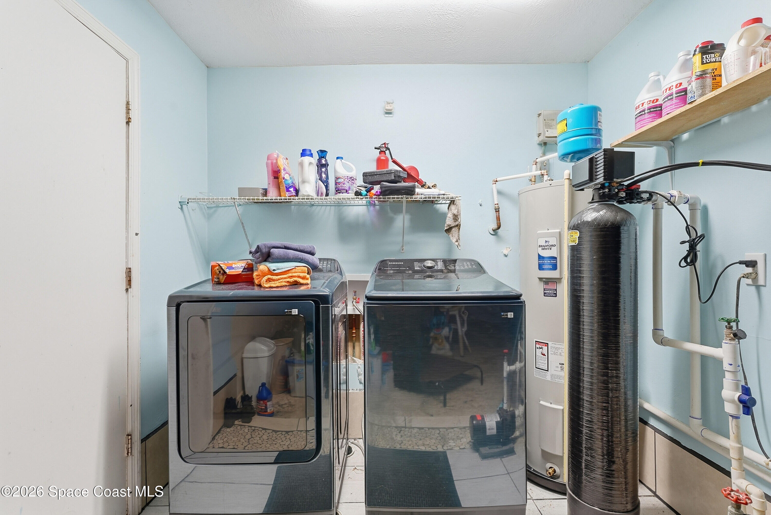 830 Garvey Road Palm Bay, FL 32908 - Photo 29 of 48 a storage room with washer and dryer