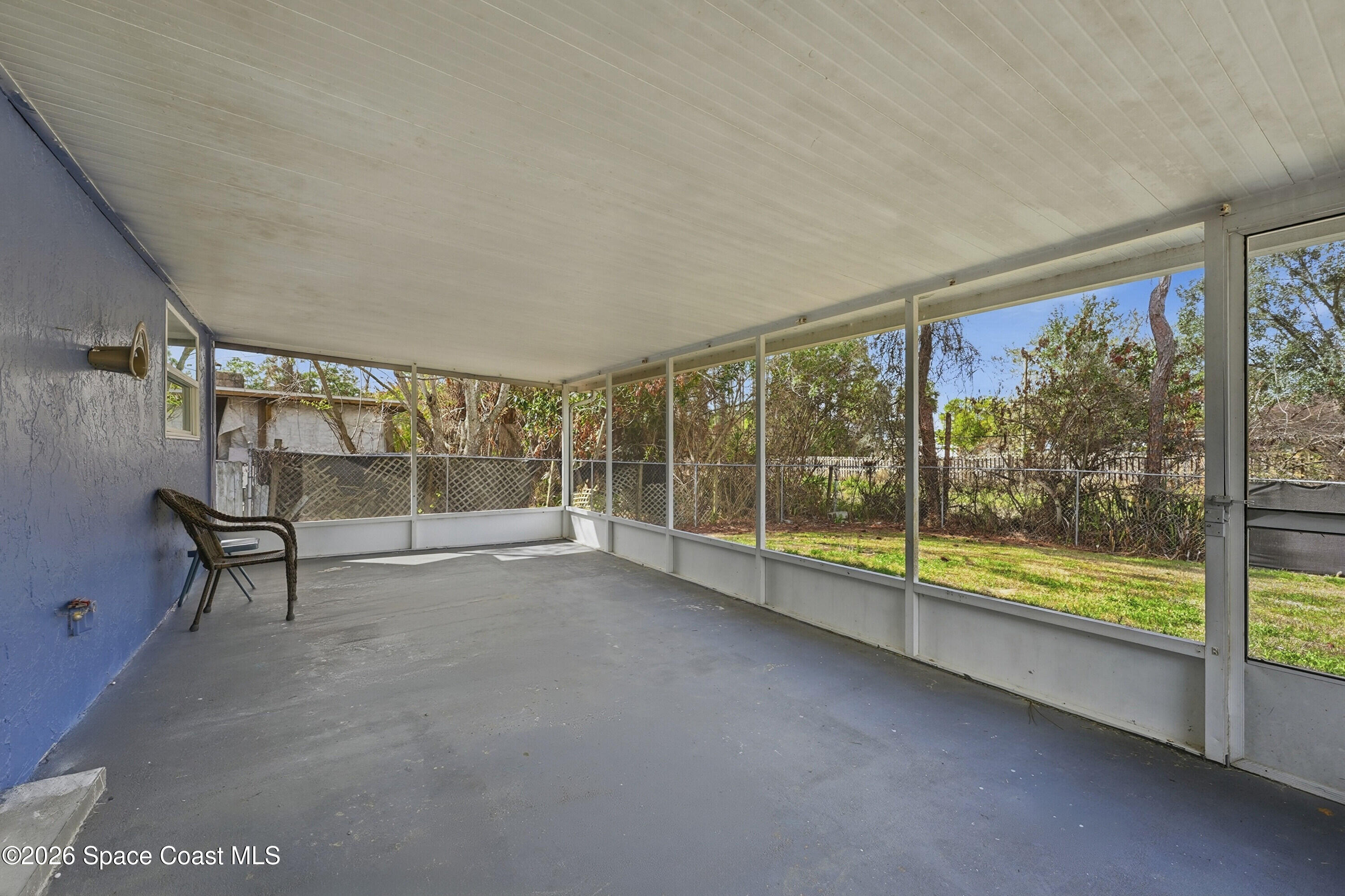 830 Garvey Road Palm Bay, FL 32908 - Photo 30 of 48 a view of an empty room with wooden floor and next to a window