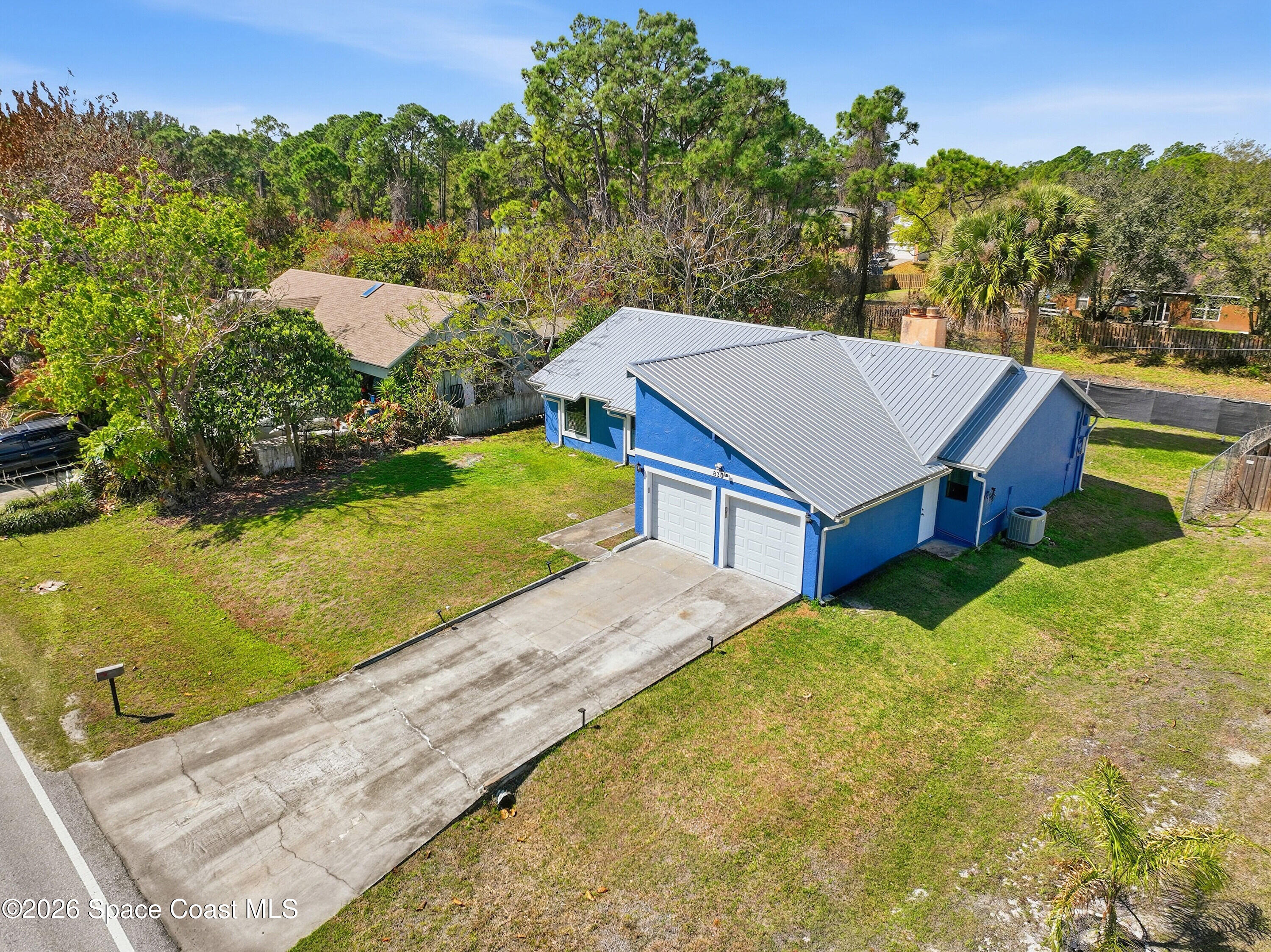 830 Garvey Road Palm Bay, FL 32908 - Photo 38 of 48 an aerial view of a house with a yard