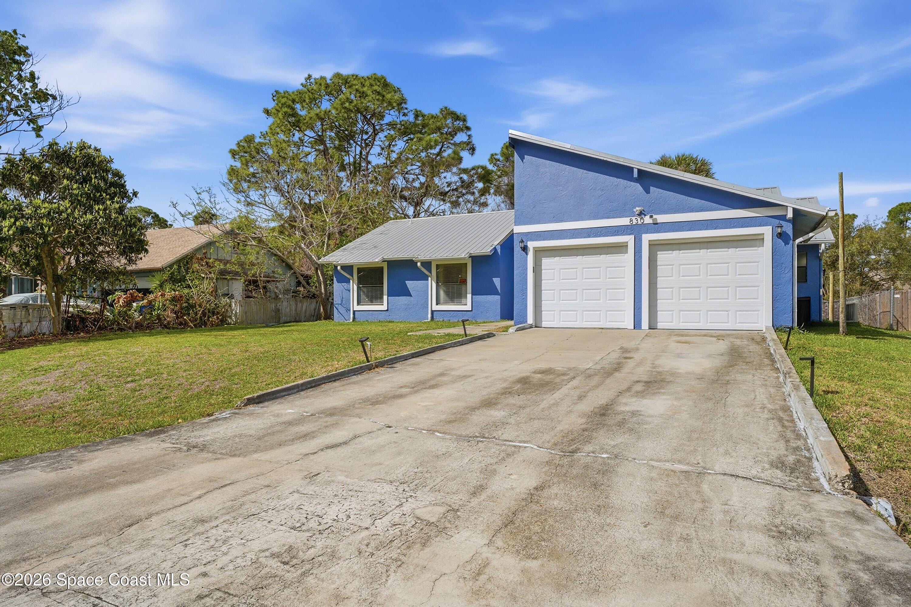 830 Garvey Road Palm Bay, FL 32908 - Photo 5 of 48 a front view of house with yard and green space