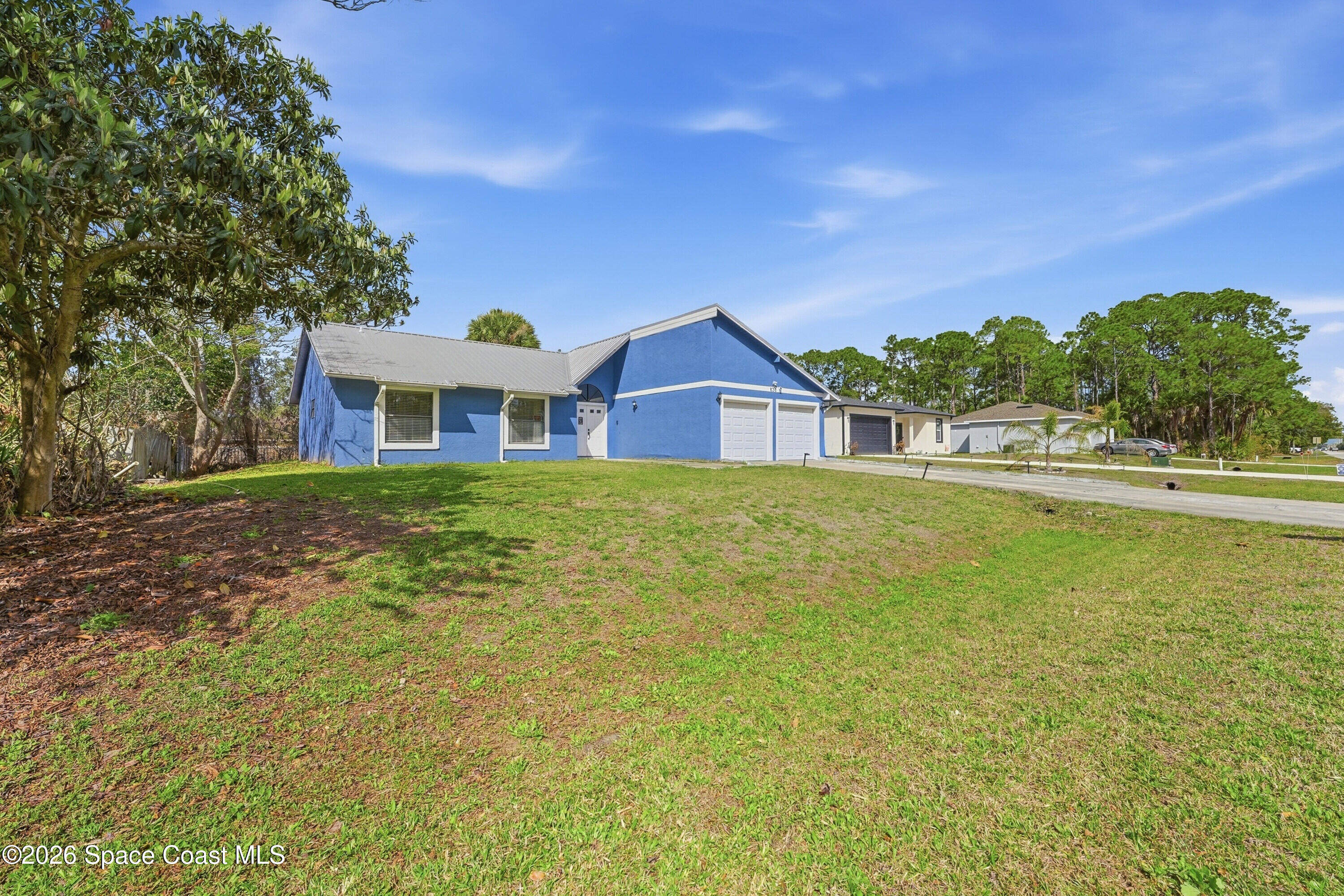 830 Garvey Road Palm Bay, FL 32908 - Photo 6 of 48 a view of a house with a big yard