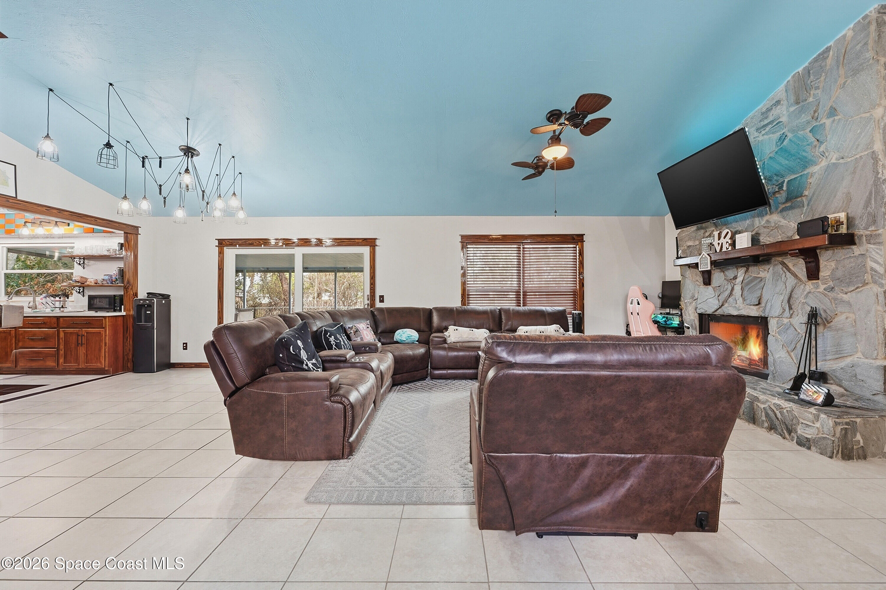 830 Garvey Road Palm Bay, FL 32908 - Photo 8 of 48 a living room with fireplace furniture and a flat screen tv