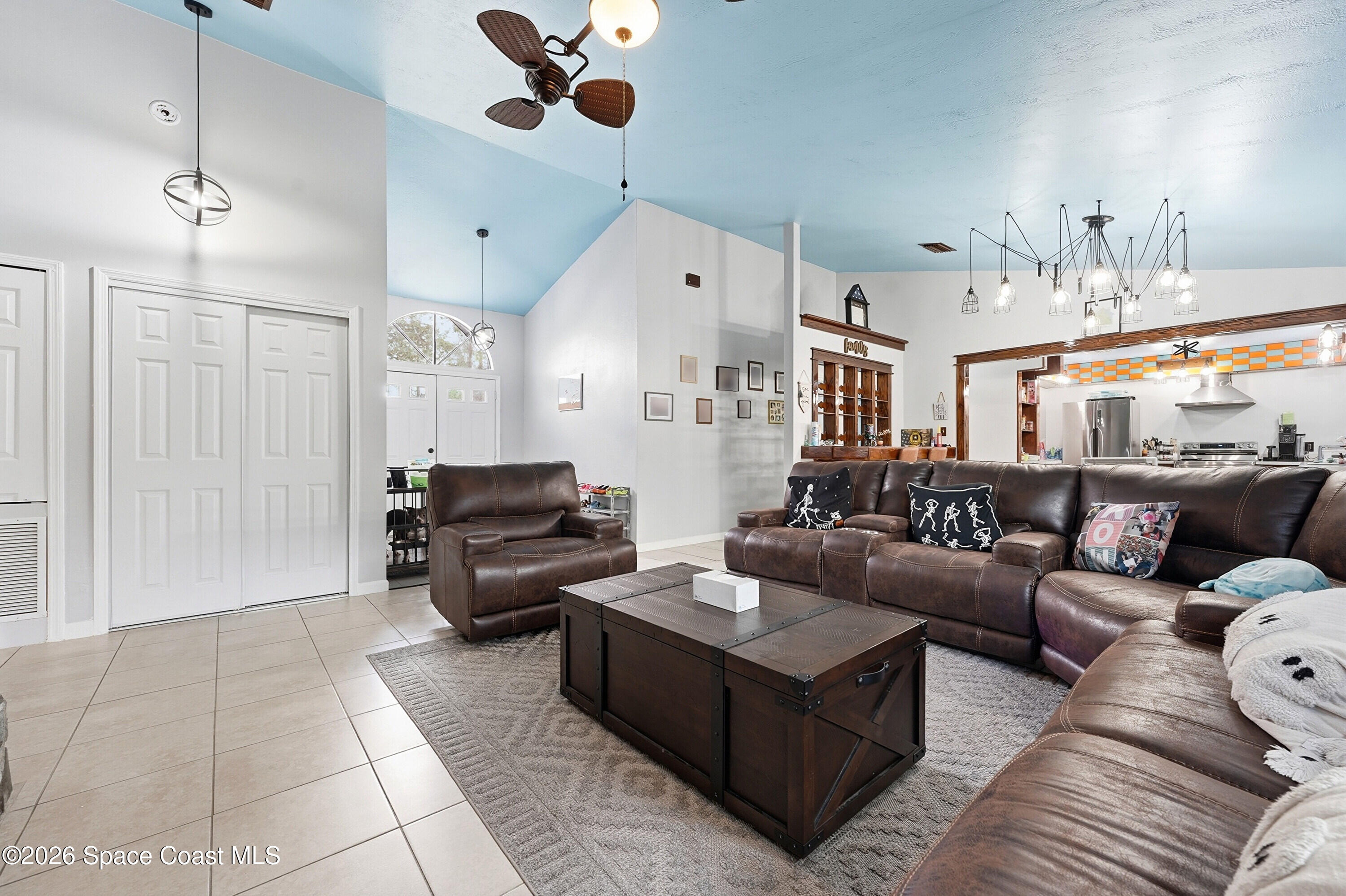 830 Garvey Road Palm Bay, FL 32908 - Photo 10 of 48 a living room with furniture and a chandelier