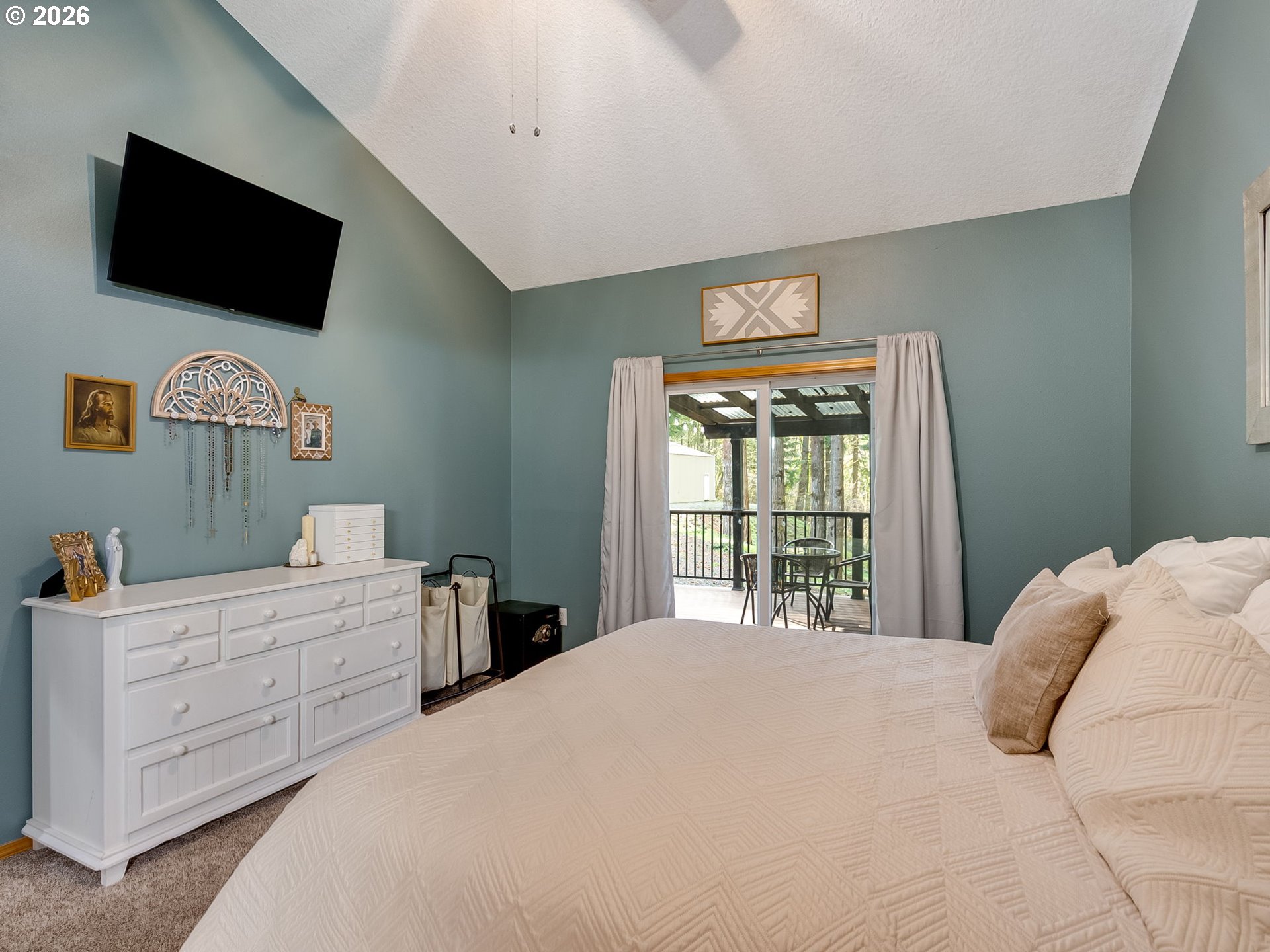 22967 South Day Hill Road Estacada, OR 97023 - Photo 17 of 40 a bedroom with a large bed and a flat screen tv