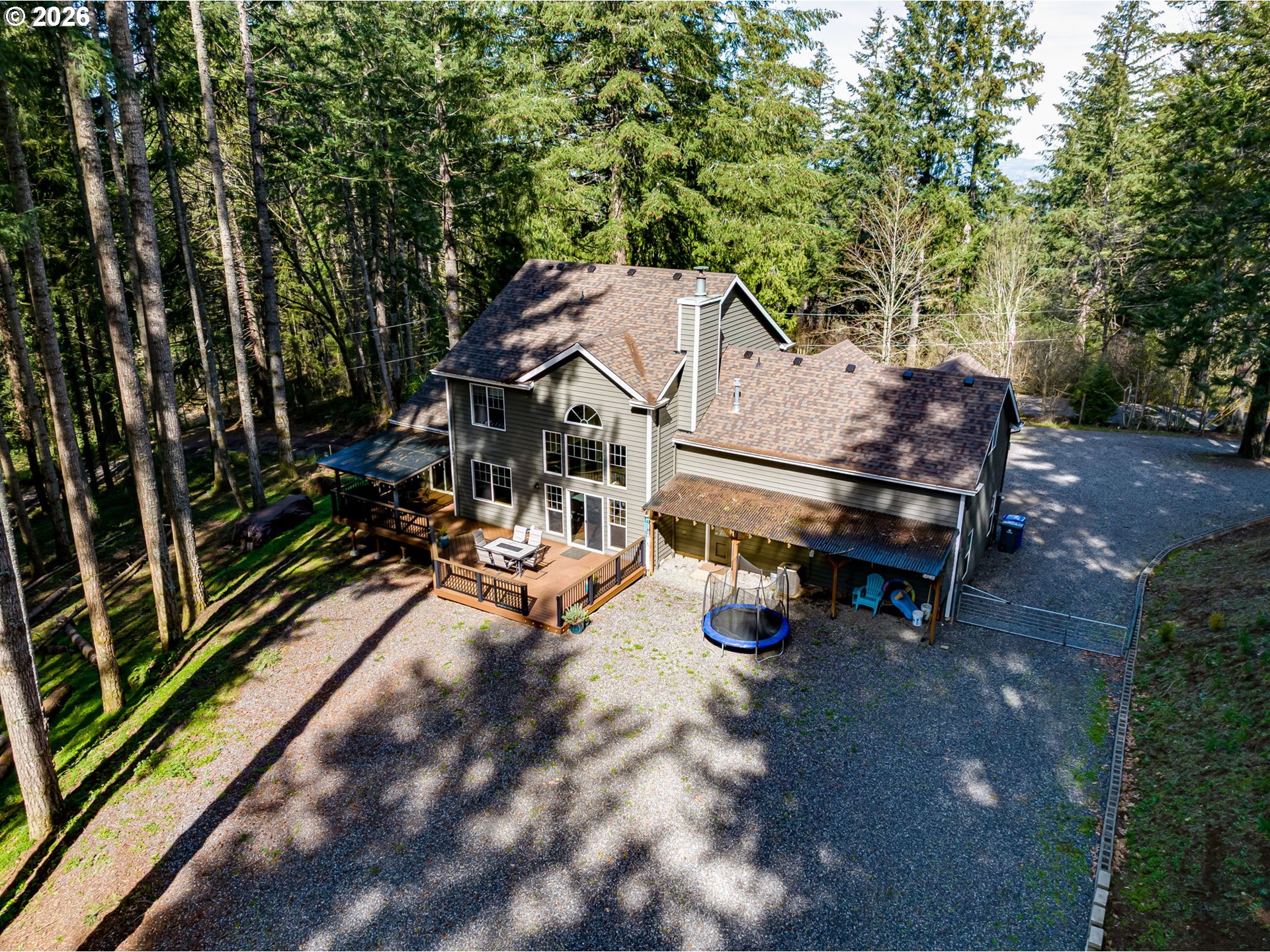 22967 South Day Hill Road Estacada, OR 97023 - Photo 2 of 40 a view of a patio with a table and chairs under an umbrella
