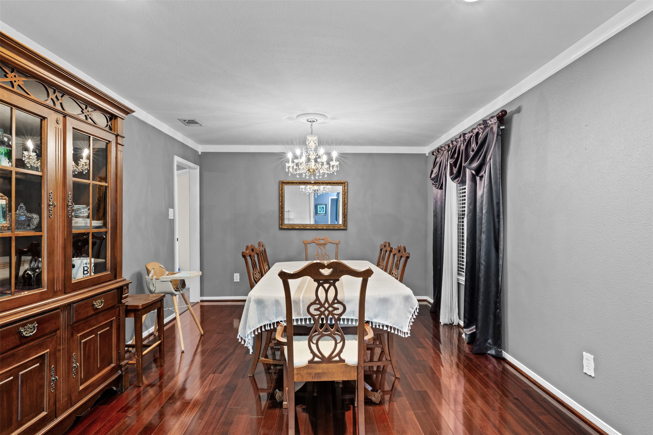 1512 Panther Loop Pflugerville, TX 78660 - Photo 6 of 40 Rich hardwood flooring complements the elegant formal dining space, ideal for hosting memorable gatherings.