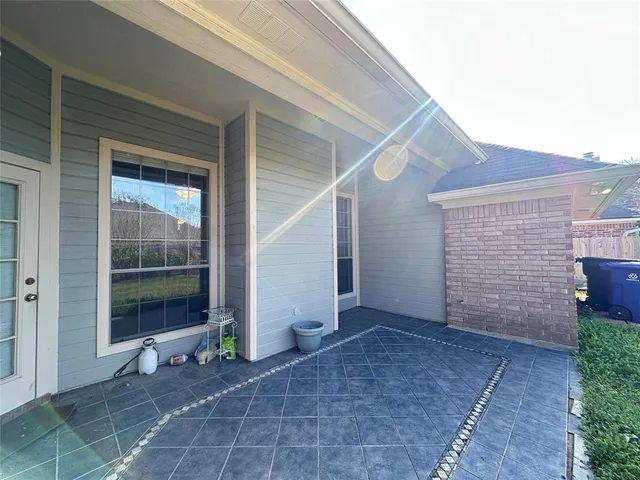 a view of a small house with backyard