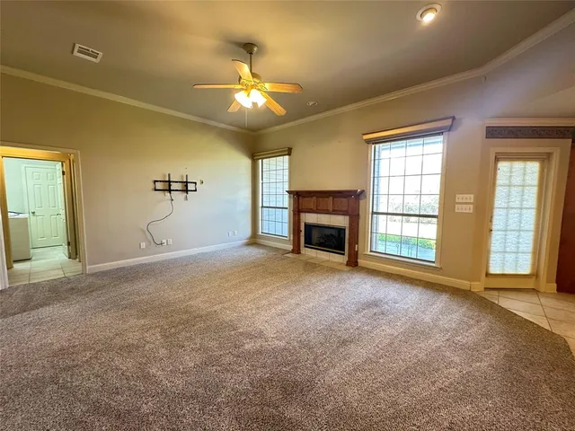 a view of empty room with a fireplace