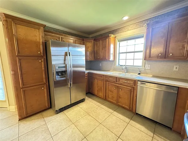 a kitchen with stainless steel appliances granite countertop a refrigerator and a sink