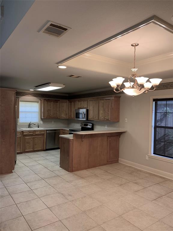 9004 Pink Pearl Court Shreveport, LA 71115 - Photo 6 of 10 a kitchen with stainless steel appliances granite countertop a sink cabinets and a counter top space