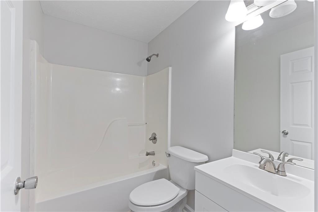 150 Fairclift Drive Covington, GA 30016 - Photo 11 of 22 a bathroom with a sink toilet vanity and shower