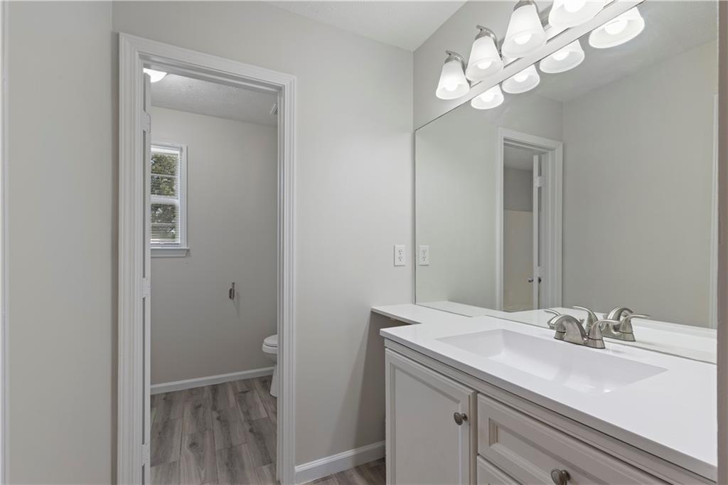 150 Fairclift Drive Covington, GA 30016 - Photo 15 of 22 a bathroom with a sink a light fixture and a mirror