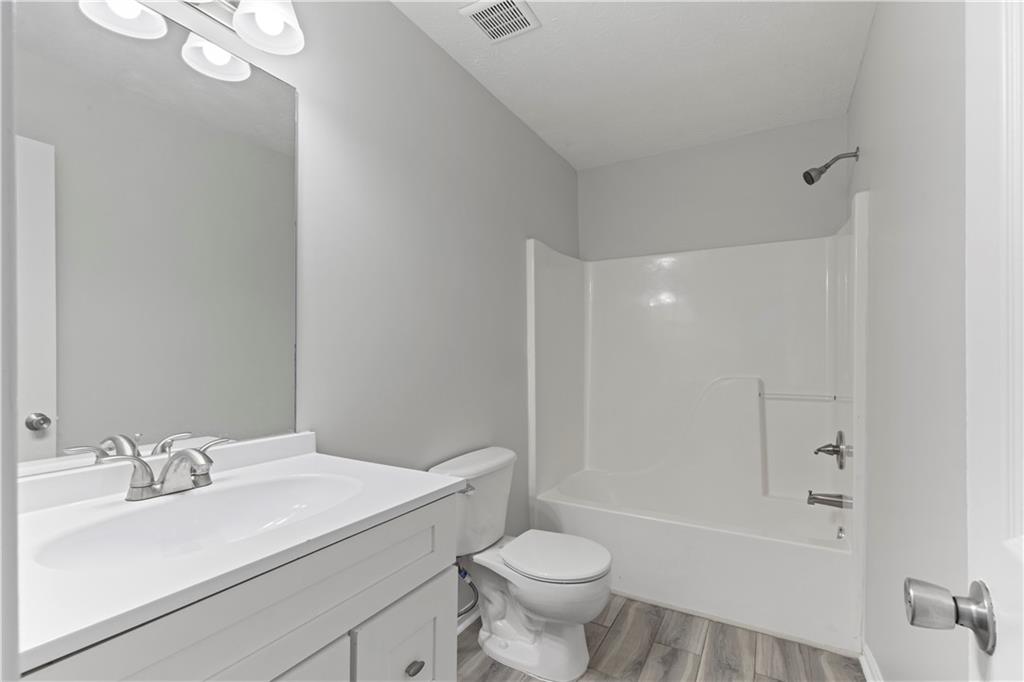 150 Fairclift Drive Covington, GA 30016 - Photo 18 of 22 a bathroom with a sink toilet vanity and shower