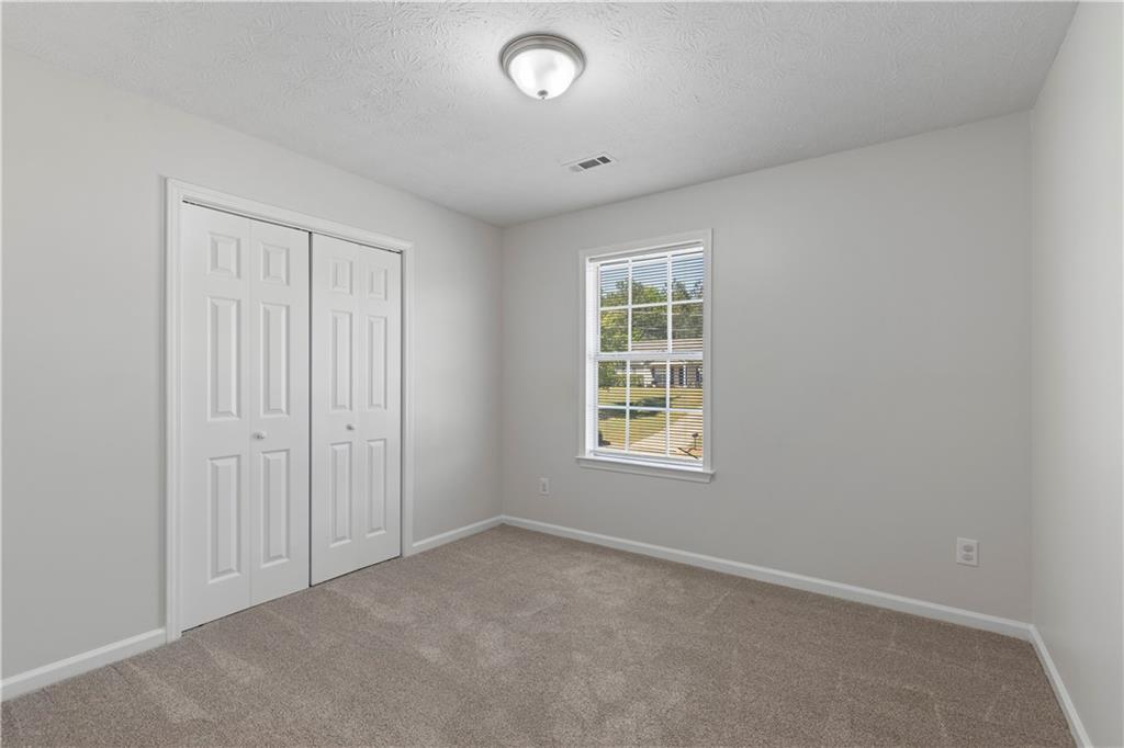 150 Fairclift Drive Covington, GA 30016 - Photo 19 of 22 an empty room with windows and closet